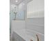 A well-lit bathroom showcases a luxurious soaking tub with white tile surround and a glass shower at 8018 Colby Cir, Orlando, FL 32817
