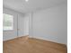 A comfortable bedroom featuring wood-look floors and a sunny window for relaxation at 8018 Colby Cir, Orlando, FL 32817