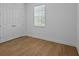 The bedroom features wood-look floors, double closets, and natural light at 8018 Colby Cir, Orlando, FL 32817