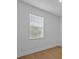 Bright bedroom featuring a window with blinds and light wood-look flooring at 8018 Colby Cir, Orlando, FL 32817