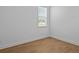 The bedroom features wood-look flooring and a window for natural light at 8018 Colby Cir, Orlando, FL 32817