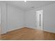 Bright bedroom with wood-look flooring and doorway leading to the bathroom at 8018 Colby Cir, Orlando, FL 32817
