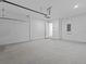 Spacious garage with concrete floors and access to interior of home at 8018 Colby Cir, Orlando, FL 32817