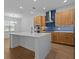 Modern kitchen featuring a large island, stainless steel appliances, and stylish wood cabinetry at 8018 Colby Cir, Orlando, FL 32817