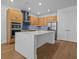 Modern kitchen featuring a large island, stainless steel appliances, and stylish wood cabinetry at 8018 Colby Cir, Orlando, FL 32817