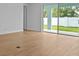 Open-concept living room with wood-look tile floors and sliding glass doors to the patio at 8018 Colby Cir, Orlando, FL 32817