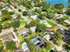 Aerial view of a neighborhood with mature trees and a glimpse of a lake in the distance at 803 Arlington Blvd, Altamonte Springs, FL 32701