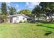 Large backyard with mature trees and partial view of the home's exterior at 803 Arlington Blvd, Altamonte Springs, FL 32701
