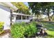 Landscaped backyard with greenery, bird bath, and partial view of the home's exterior at 803 Arlington Blvd, Altamonte Springs, FL 32701