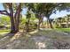 Expansive backyard with mature trees and a charming wooden swing set at 803 Arlington Blvd, Altamonte Springs, FL 32701