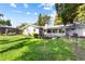 Spacious backyard with mature trees and partial view of the back side of the home at 803 Arlington Blvd, Altamonte Springs, FL 32701