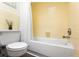 Bathroom featuring a toilet, tub with shower and yellow tile at 803 Arlington Blvd, Altamonte Springs, FL 32701