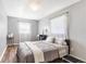 Bedroom with grey walls, wood-look floors, and windows with sheer white curtains at 803 Arlington Blvd, Altamonte Springs, FL 32701