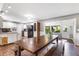 Dining area with large wooden table open to the kitchen with white cabinets at 803 Arlington Blvd, Altamonte Springs, FL 32701