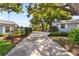 Wide driveway lined with neatly manicured landscaping and beautiful, mature trees at 803 Arlington Blvd, Altamonte Springs, FL 32701