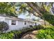 Charming home featuring a well-maintained lawn, lush plants, and classic white trim at 803 Arlington Blvd, Altamonte Springs, FL 32701