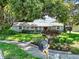 Quaint one-story home with a well-kept lawn, garden beds, and a welcoming mailbox at 803 Arlington Blvd, Altamonte Springs, FL 32701