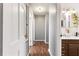 Hallway leading to the bathroom with hardwood floors and white doors at 803 Arlington Blvd, Altamonte Springs, FL 32701