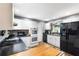 Bright kitchen features white cabinetry, black appliances and a wooden island on hardwood floors at 803 Arlington Blvd, Altamonte Springs, FL 32701