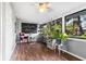 Bright sun room features wood flooring, lots of natural light, chalkboard, and decorative plants at 803 Arlington Blvd, Altamonte Springs, FL 32701