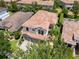 Aerial view of home showcasing tile roof, well-manicured landscaping, and a three-car garage at 8439 Prestbury Dr, Orlando, FL 32832