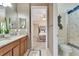 Bright bathroom with granite counters, double sinks, and doorway to the bedroom with ensuite bath and toilet at 8439 Prestbury Dr, Orlando, FL 32832