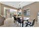 Modern dining room featuring a wooden table, chandelier lighting and staircase access at 8439 Prestbury Dr, Orlando, FL 32832