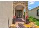 Inviting entryway with a decorative stone archway, brick walkway, and potted plants at 8439 Prestbury Dr, Orlando, FL 32832
