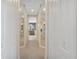 Hallway with carpet and mirrored closet doors leading to the main bathroom at 8439 Prestbury Dr, Orlando, FL 32832