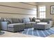 Comfortable living room featuring a large sectional sofa, and a blue patterned rug at 8439 Prestbury Dr, Orlando, FL 32832