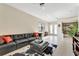 Bright living room featuring a leather sectional, tile floors, and white trim at 8439 Prestbury Dr, Orlando, FL 32832