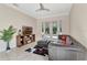 Living room features an entertainment center and a large leather couch, with doors opening to the backyard pool at 8439 Prestbury Dr, Orlando, FL 32832