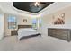 Bright main bedroom features tray ceilings, recessed lighting, large windows, and a ceiling fan at 8439 Prestbury Dr, Orlando, FL 32832