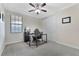 Office with closet space, a ceiling fan, a window, and a desk perfect for a quiet work environment at 8439 Prestbury Dr, Orlando, FL 32832