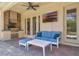 Covered outdoor patio with stainless grill, brick accent wall, and comfortable seating at 8439 Prestbury Dr, Orlando, FL 32832