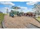 Community playground features a climbing wall, a slide, and seating areas all surrounded by landscaping and fencing at 8439 Prestbury Dr, Orlando, FL 32832