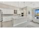 A modern kitchen with an island, stainless steel appliances, and bright lighting at 891 Megano Blvd, Deland, FL 32724