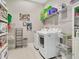 Well-organized laundry room with a side-by-side washer and dryer and ample shelving units at 891 Megano Blvd, Deland, FL 32724