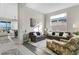 A modern living room with stylish furniture, bright lighting, and beautiful flooring at 891 Megano Blvd, Deland, FL 32724