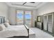 A serene main bedroom with a large window offering beautiful water views and ample closet space at 891 Megano Blvd, Deland, FL 32724