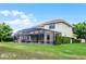 Spacious backyard featuring a screened-in pool, patio, and lush green lawn at 9104 Stromboli Ct, Kissimmee, FL 34747