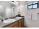 Bathroom featuring double sinks, granite counters, and a well-lit mirror at 9104 Stromboli Ct, Kissimmee, FL 34747