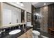 Bathroom with a decorative vanity, walk-in shower, and stylish tiling at 9104 Stromboli Ct, Kissimmee, FL 34747