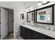 Bathroom with dual sinks, vanity, and a large mirror at 9104 Stromboli Ct, Kissimmee, FL 34747