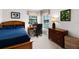 Comfortable bedroom with a work desk by the window, dresser, and a bed at 9104 Stromboli Ct, Kissimmee, FL 34747