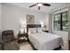 Bedroom with neutral tones, ceiling fan, and a comfortable seating area at 9104 Stromboli Ct, Kissimmee, FL 34747