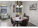 Cozy breakfast nook with a round table, seating for four, and a view of the outdoor area at 9104 Stromboli Ct, Kissimmee, FL 34747