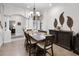 Formal dining room featuring a long wooden table, seating for six, and decorative accents for elegant dining at 9104 Stromboli Ct, Kissimmee, FL 34747