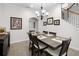 Formal dining room featuring a wooden table with seating for six, complemented by elegant decor and a stairway at 9104 Stromboli Ct, Kissimmee, FL 34747