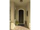 Charming home entrance featuring a decorative front door with an adjacent potted plant display on a brick-paved entryway at 9104 Stromboli Ct, Kissimmee, FL 34747